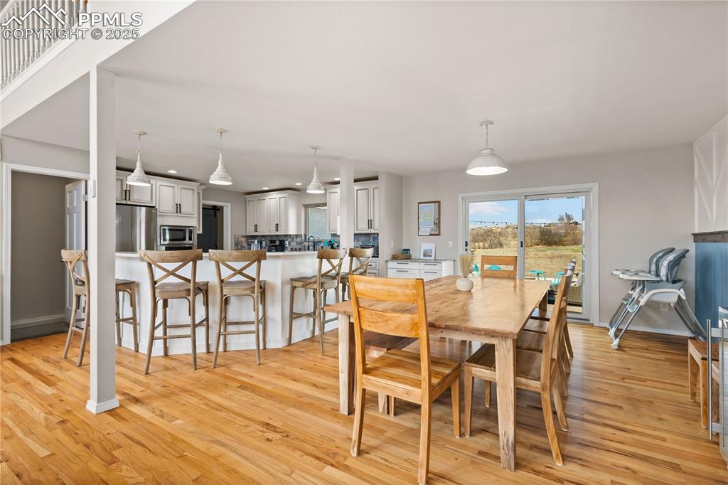 545 Struthers Loop Colorado Springs, CO 80921 - Photo 10 of 48 a dining room with furniture and wooden floor