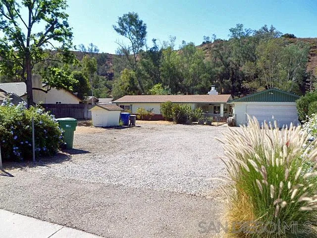 9236 Los Coches Road Lakeside, CA 92040 - Photo 1 of 27 a view of a house with a yard and sitting area