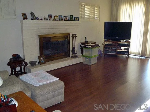 9236 Los Coches Road Lakeside, CA 92040 - Photo 11 of 27 a living room with furniture a fireplace and a flat screen tv