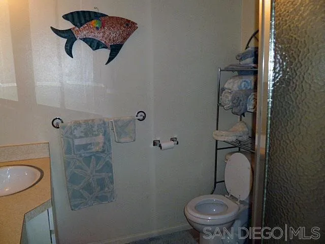 9236 Los Coches Road Lakeside, CA 92040 - Photo 12 of 27 a white toilet sitting next to a shower