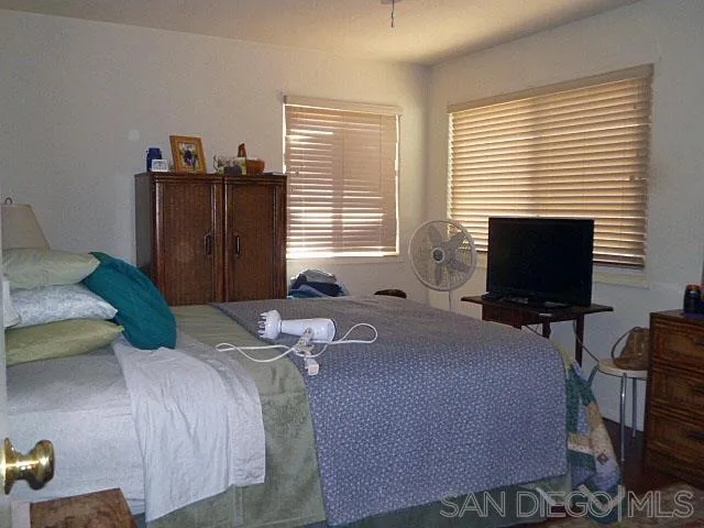 9236 Los Coches Road Lakeside, CA 92040 - Photo 13 of 27 a bedroom with a bed and wooden floor