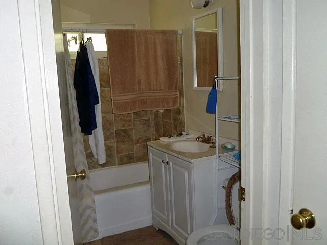 9236 Los Coches Road Lakeside, CA 92040 - Photo 14 of 27 a bathroom with a sink and mirror