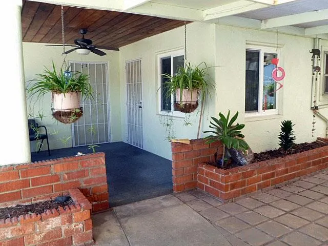 9236 Los Coches Road Lakeside, CA 92040 - Photo 3 of 27 a living room with furniture and potted plants