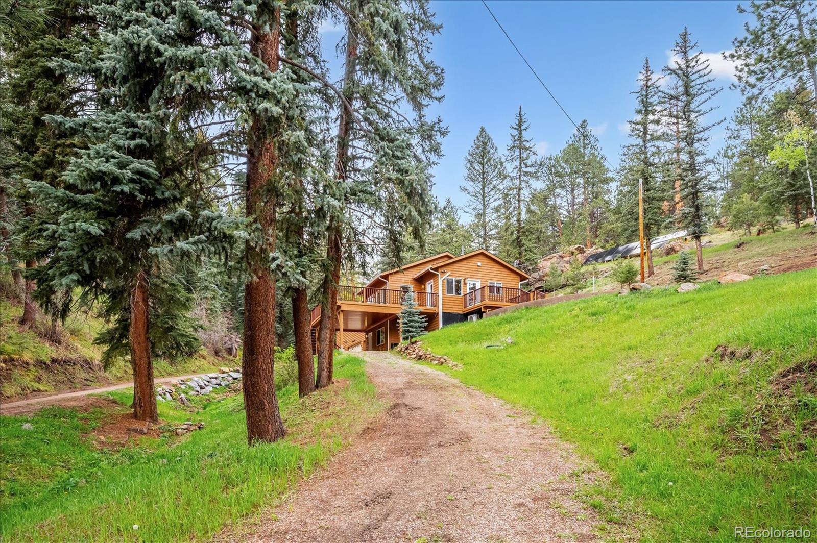 6747 South Brook Forest Road Evergreen, CO 80439 - Photo 2 of 49 a view of a house with a yard