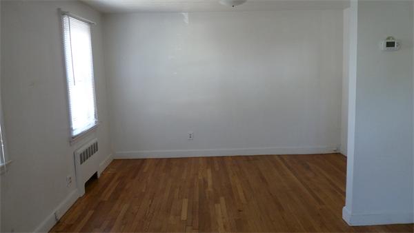 46-48 Hatfield Road Newton, MA 02465 - Photo 3 of 11 an empty room with wooden floor and windows
