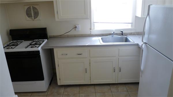 46-48 Hatfield Road Newton, MA 02465 - Photo 4 of 11 a room with cabinets and a stove