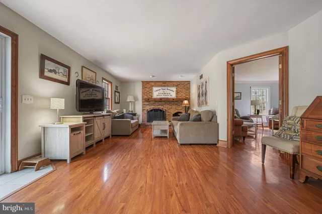 a living room with furniture flat screen tv and a fireplace
