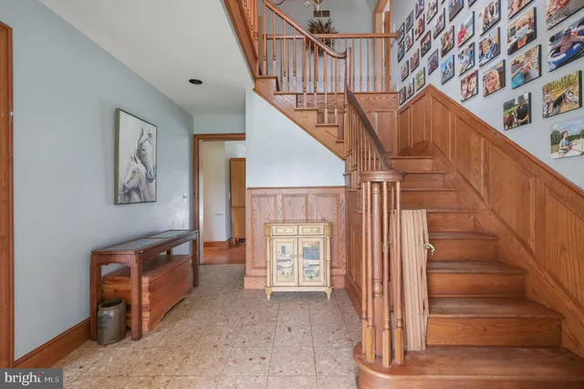 a view of entryway with wooden floor and stairs