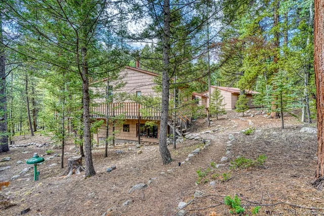a view of a chair and table on the deck