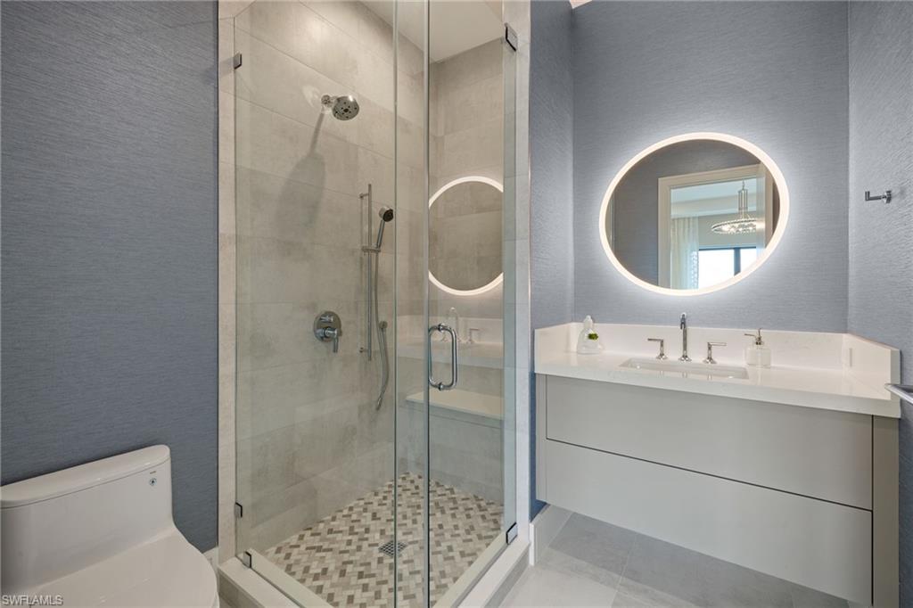 2345 Tarpon Road Naples, FL 34102 - Photo 33 of 43 Full bath featuring a textured wall, a stall shower, and vanity