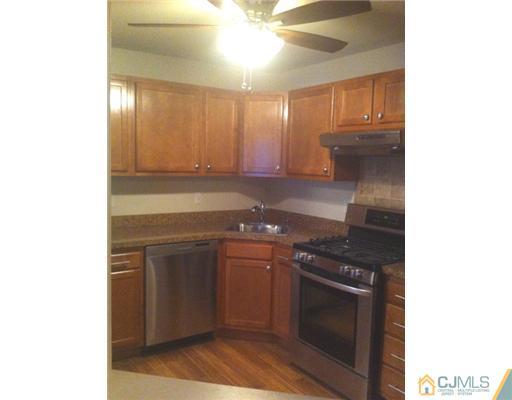 306 Raintree Court Helmetta, NJ 08828 - Photo 3 of 15 a kitchen with stainless steel appliances granite countertop a stove and a sink