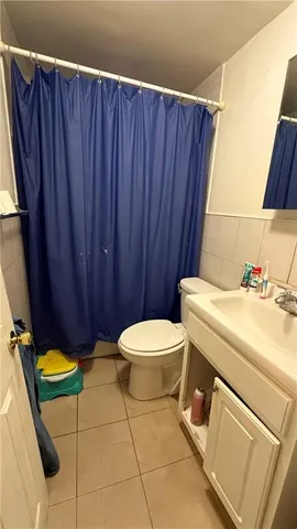 a bathroom with a sink a toilet and a shower