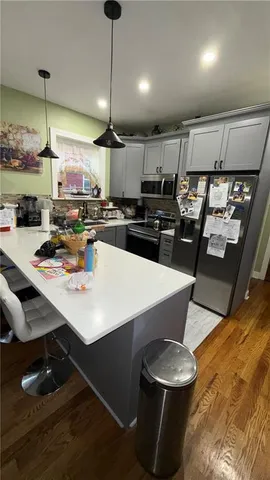 a kitchen with a table chairs and a wooden floor