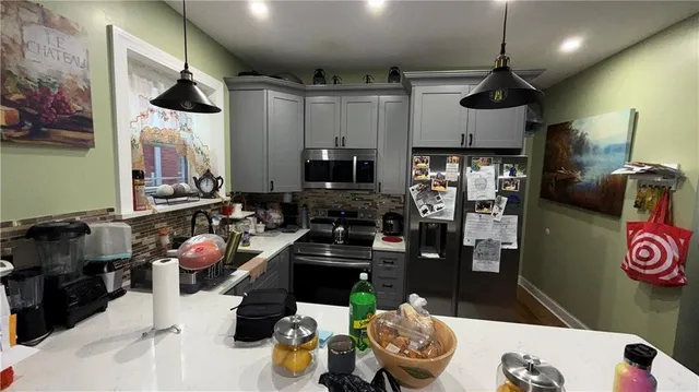 a kitchen with a refrigerator and a stove