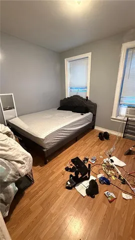 a bedroom with two bed and a window