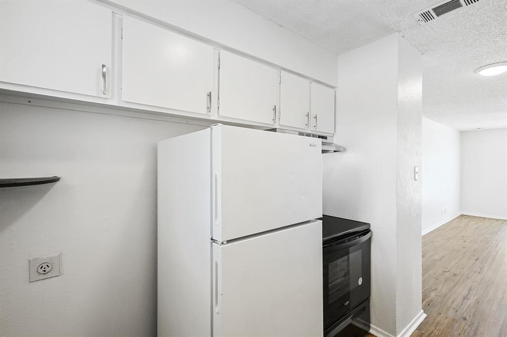 2637 West Randol Mill Road, Unit A Arlington, TX 76012 - Photo 12 of 13 a view of a kitchen with refrigerator and cabinet