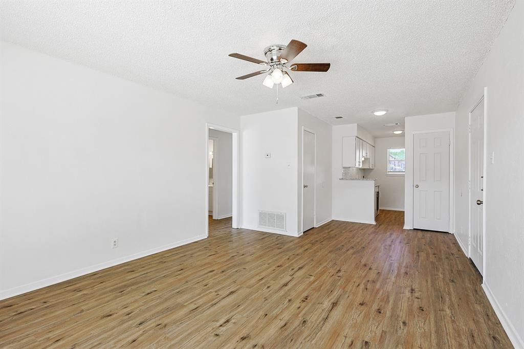 2637 West Randol Mill Road, Unit A Arlington, TX 76012 - Photo 13 of 13 a view of a livingroom with a ceiling fan & wooden floor