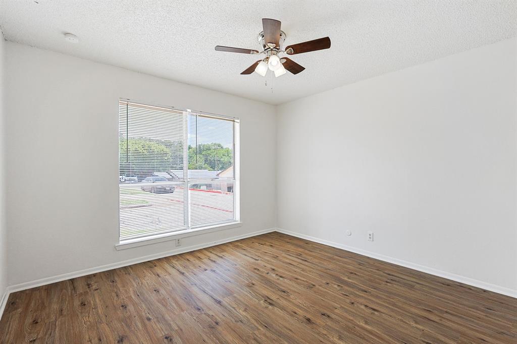 2637 West Randol Mill Road, Unit A Arlington, TX 76012 - Photo 9 of 13 an empty room with wooden floor and windows