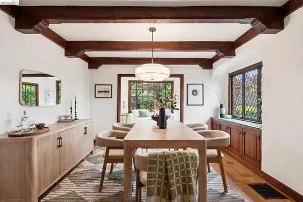 a view of a dining room with furniture large windows and wooden floor