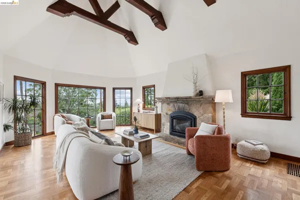 a living room with furniture large window and fireplace