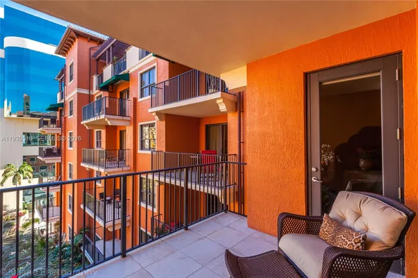 a balcony with table and chairs