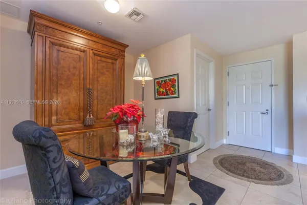 a kitchen with refrigerator and cabinets