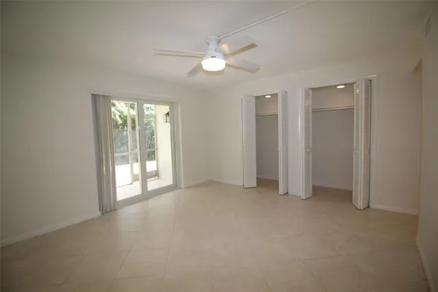 an empty room with windows and closet