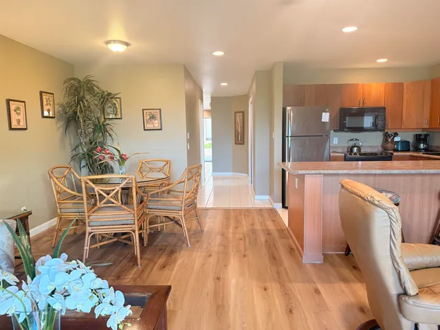 a dining room with furniture and a wooden floor