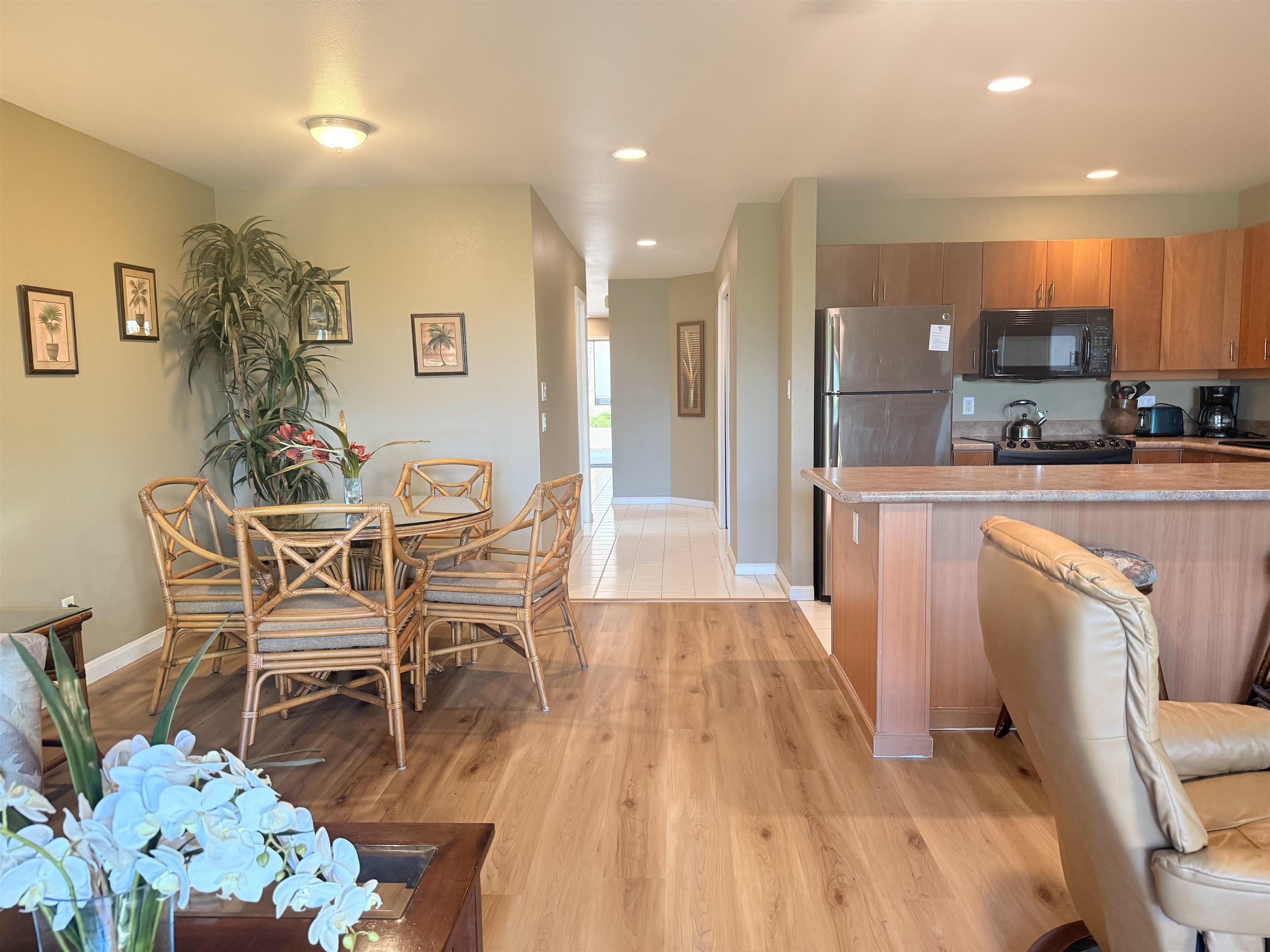 a dining room with furniture and a wooden floor