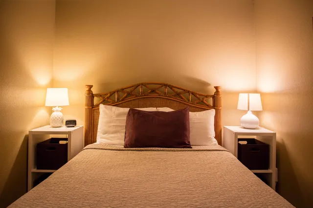 a bedroom with a bed and a lamp