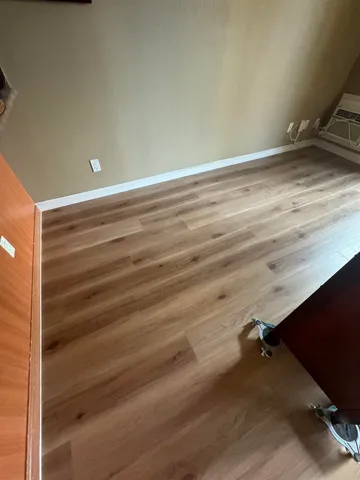 a view of a room with wooden floor