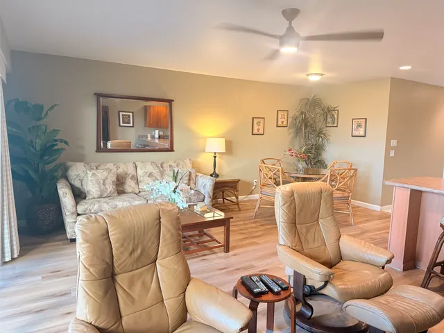 a living room with furniture and a wooden floor