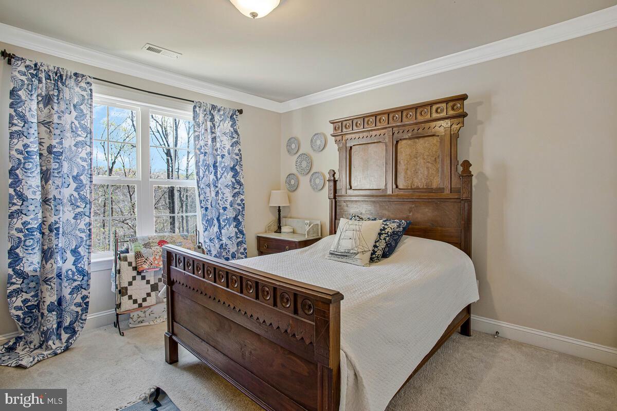 54 Simmons Ridge Road Prince Frederick, MD 20678 - Photo 24 of 55 a bedroom with a bed and a table