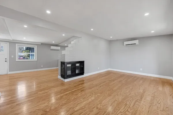 a view of an empty room with wooden floor