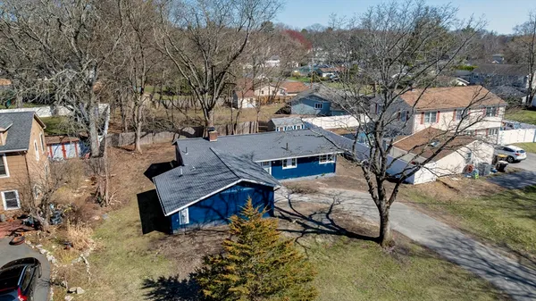 a view of a house with a yard covered in snow
