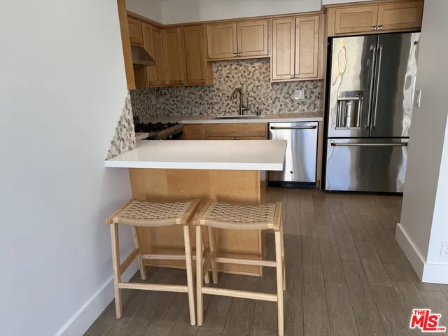 a kitchen with a sink cabinets and stainless steel appliances