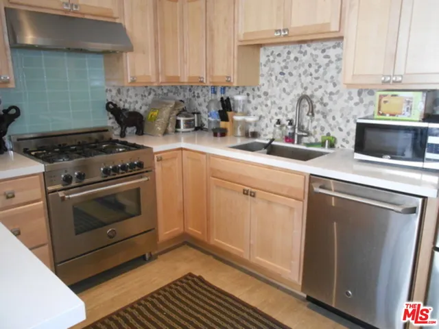 a kitchen with a stove and white cabinets