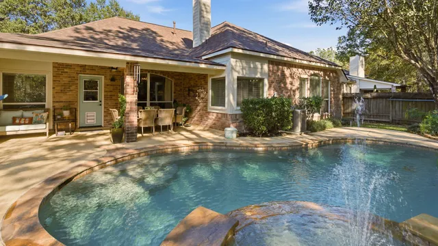 a view of a house with pool and sitting area