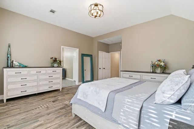 a bathroom with a double vanity sink mirror and bathtub