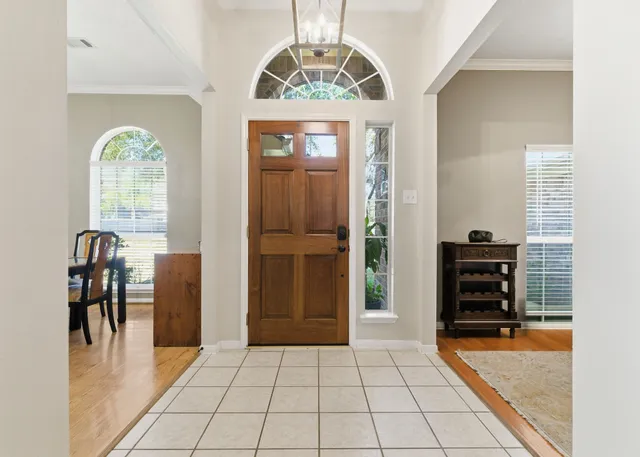 a view of a dining room with furniture wooden floor and chandelier