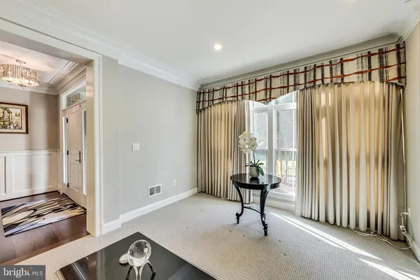a living room with lots of furniture and wooden floor