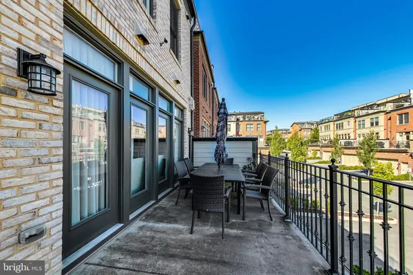 a spacious bedroom with a bed a dresser and a flat screen tv