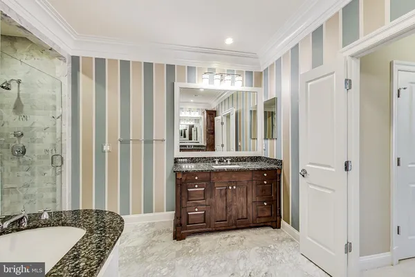 a large bedroom with a bed and a dresser in it