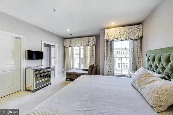 a view of walk in closet with wooden floor