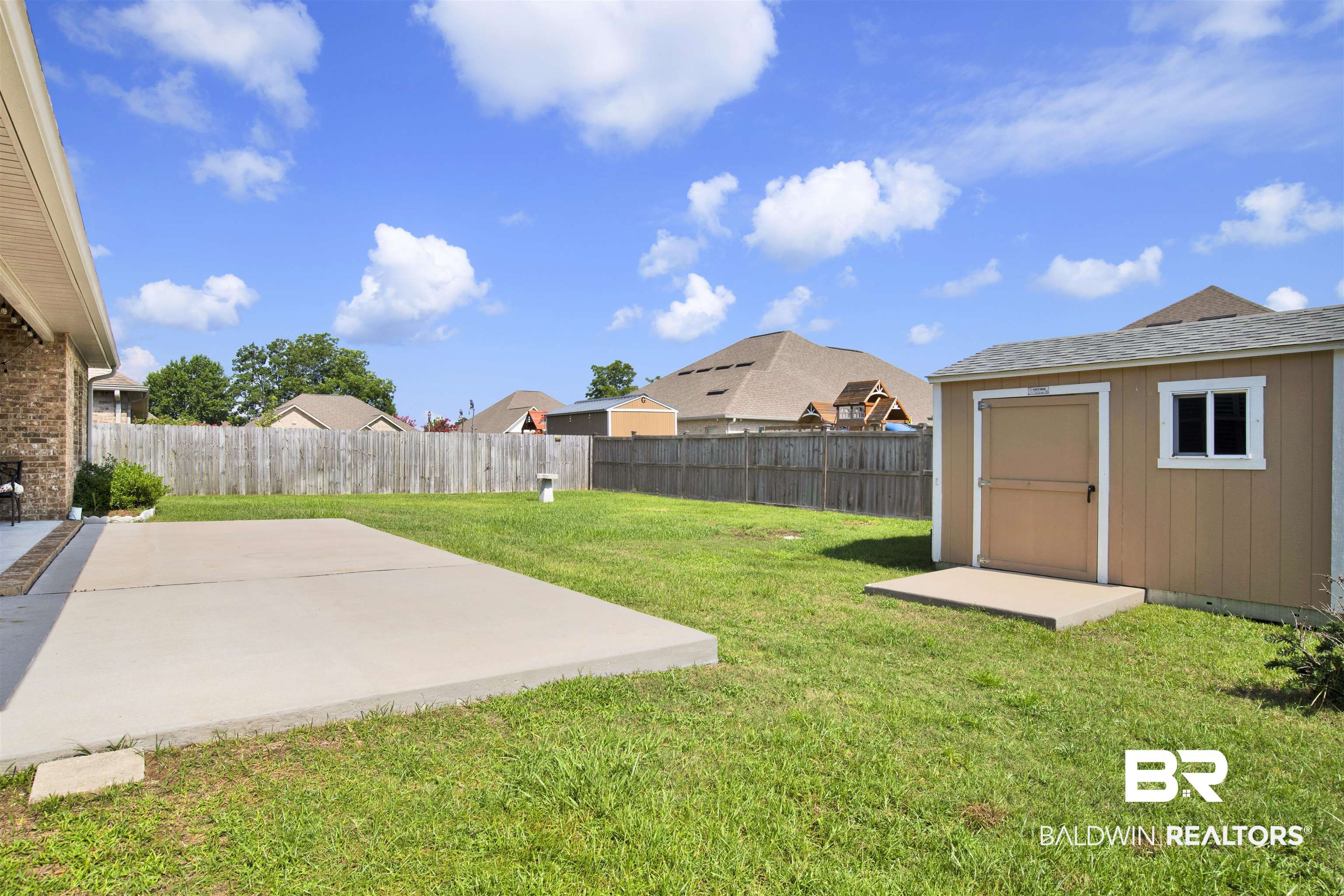 278 Silo Loop Fairhope, AL 36532 - Photo 22 of 26 Fenced backyard featuring a shed and a patio