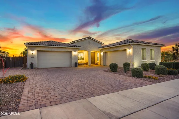 a front view of a house with a yard and a garage