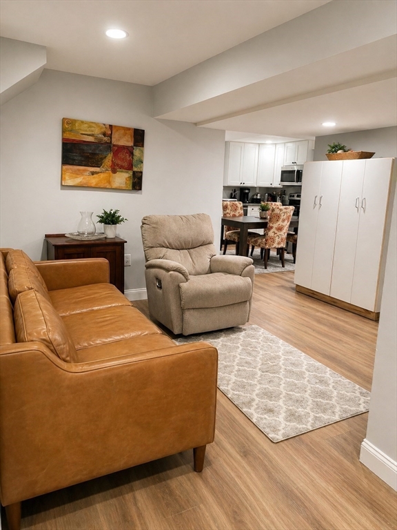 5 Rebecca Road Newton, MA 02465 - Photo 20 of 42 a living room with furniture and a flat screen tv