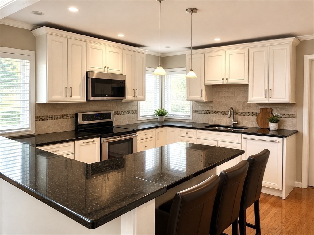 5 Rebecca Road Newton, MA 02465 - Photo 3 of 42 a kitchen with stainless steel appliances granite countertop a sink a stove top oven a counter space and cabinets