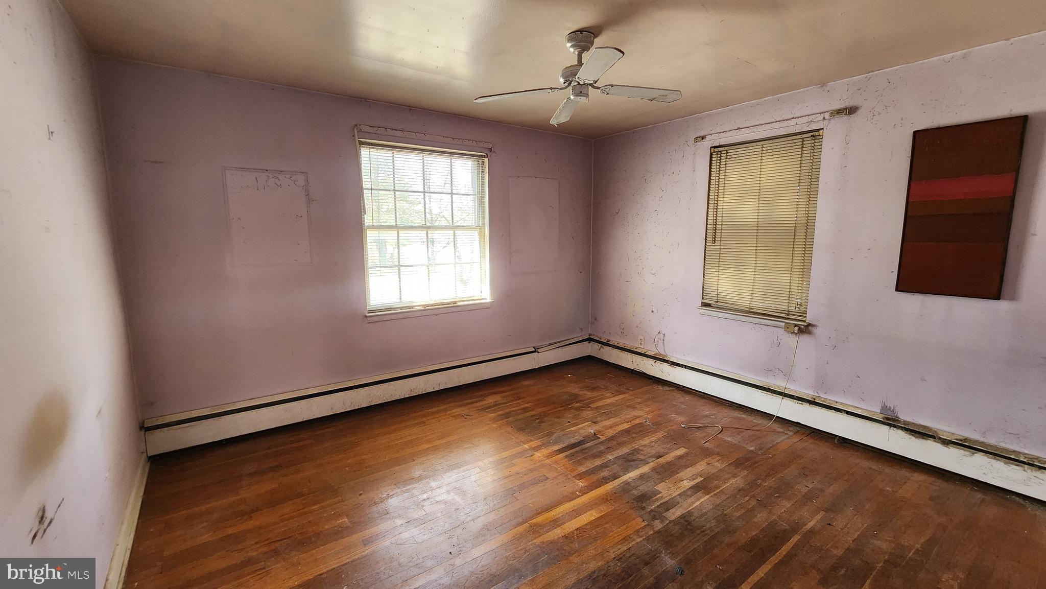 936 Olmstead Road Baltimore, MD 21208 - Photo 16 of 24 wooden floor in an empty room with a window