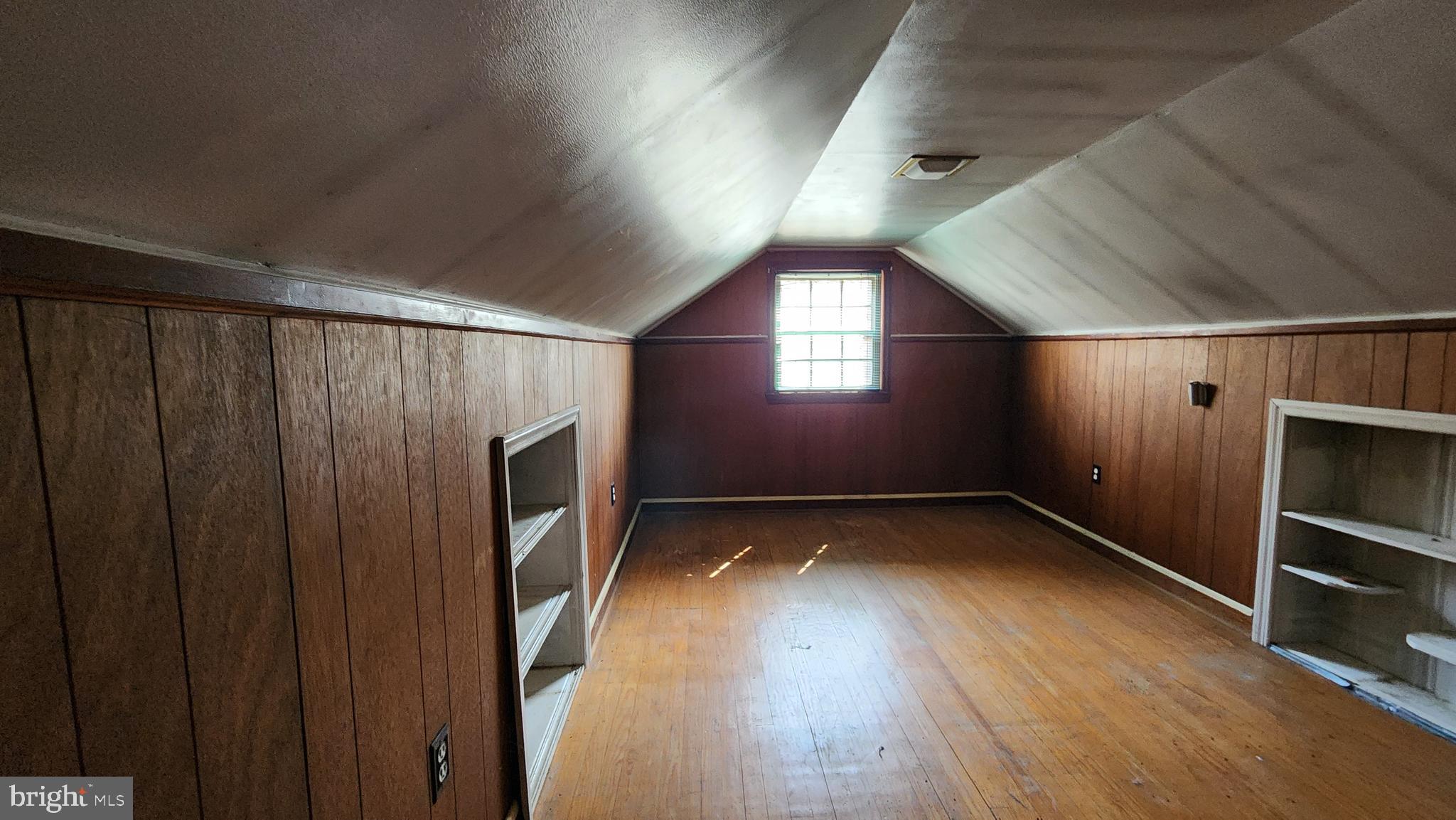 936 Olmstead Road Baltimore, MD 21208 - Photo 19 of 24 a view of an empty room with a fireplace and a window